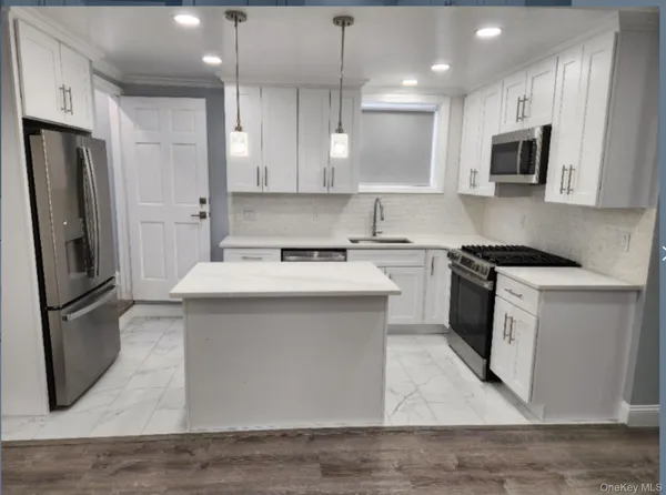 a kitchen with a sink stainless steel appliances and cabinets