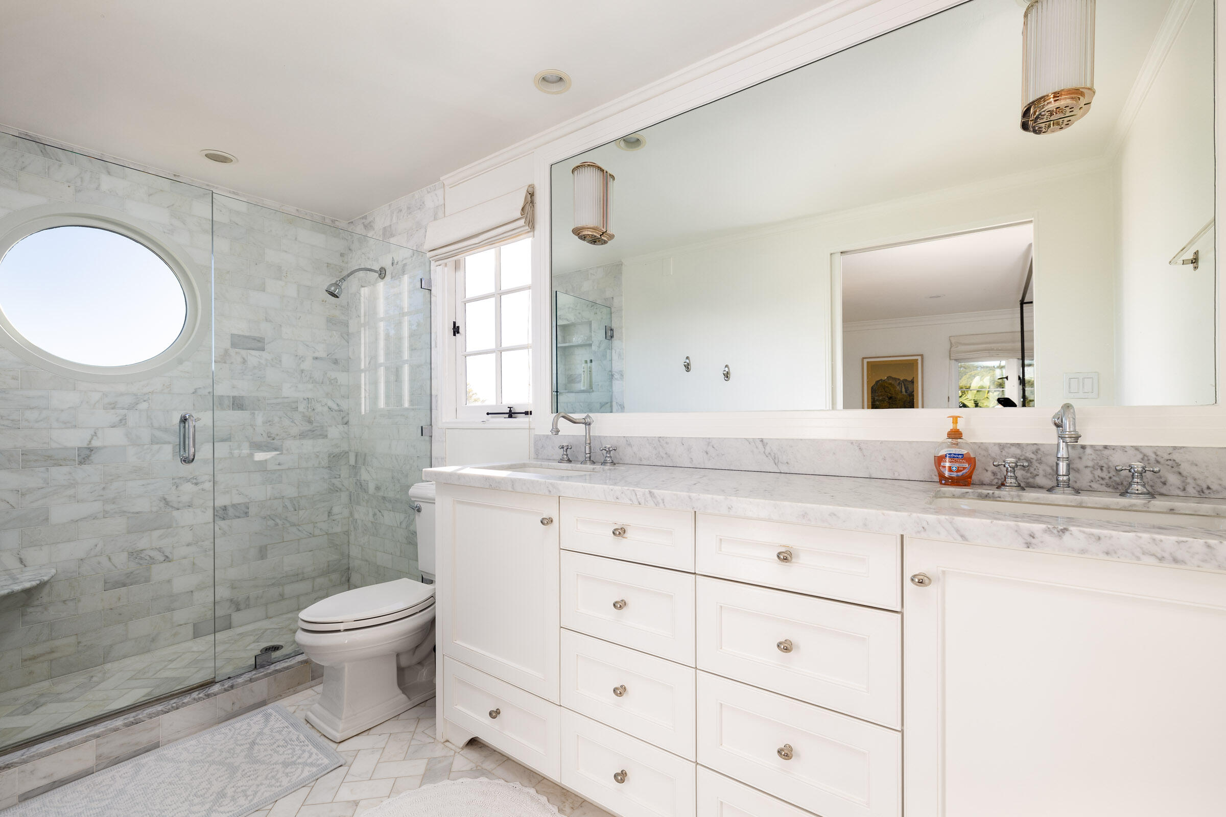 1933 Mission Ridge Road Santa Barbara, CA 93103 - Photo 15 of 30 a bathroom with a granite countertop sink toilet a large mirror a shower and a mirror