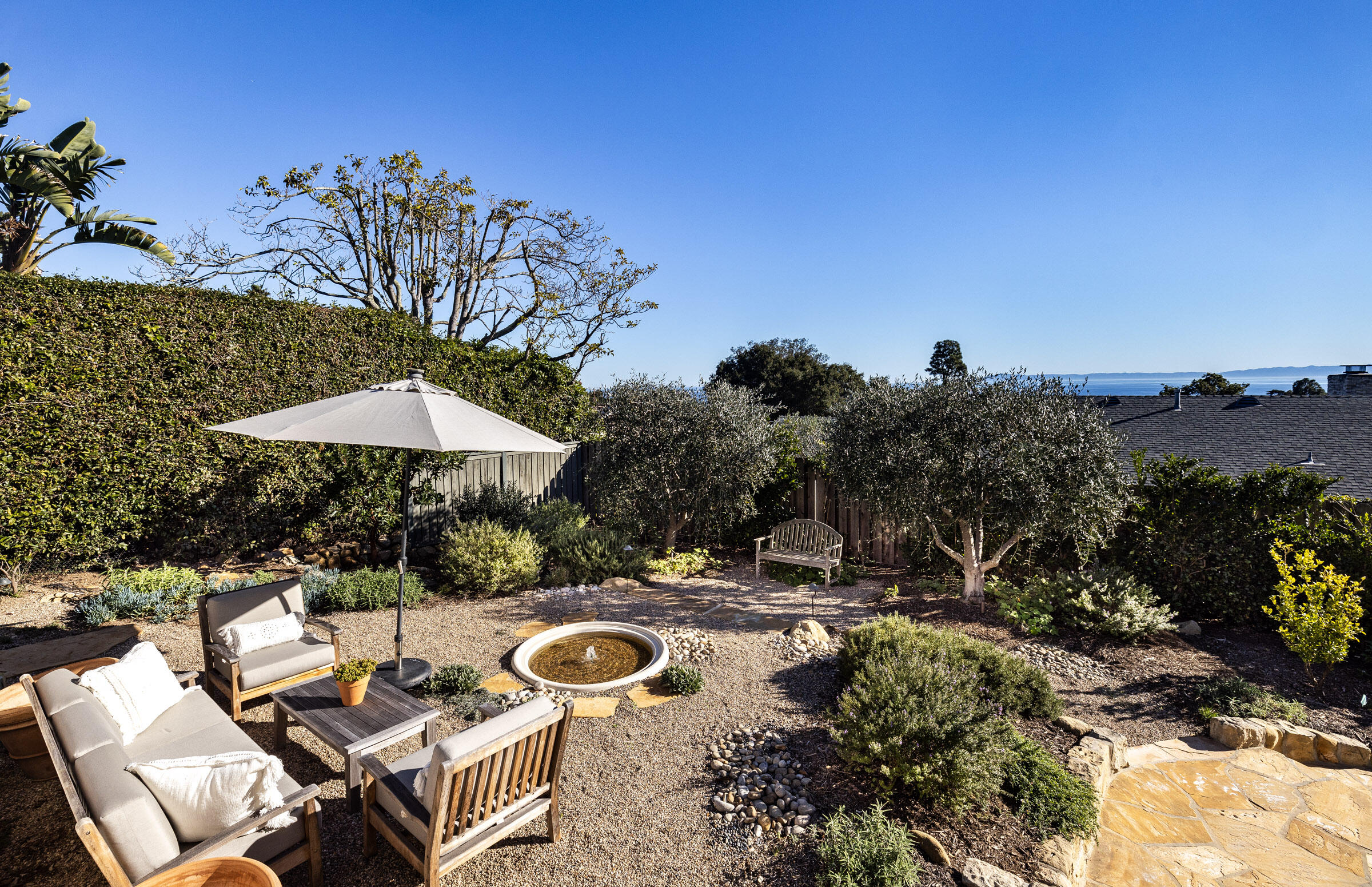 1933 Mission Ridge Road Santa Barbara, CA 93103 - Photo 22 of 30 a view of backyard with seating space and trees in the background