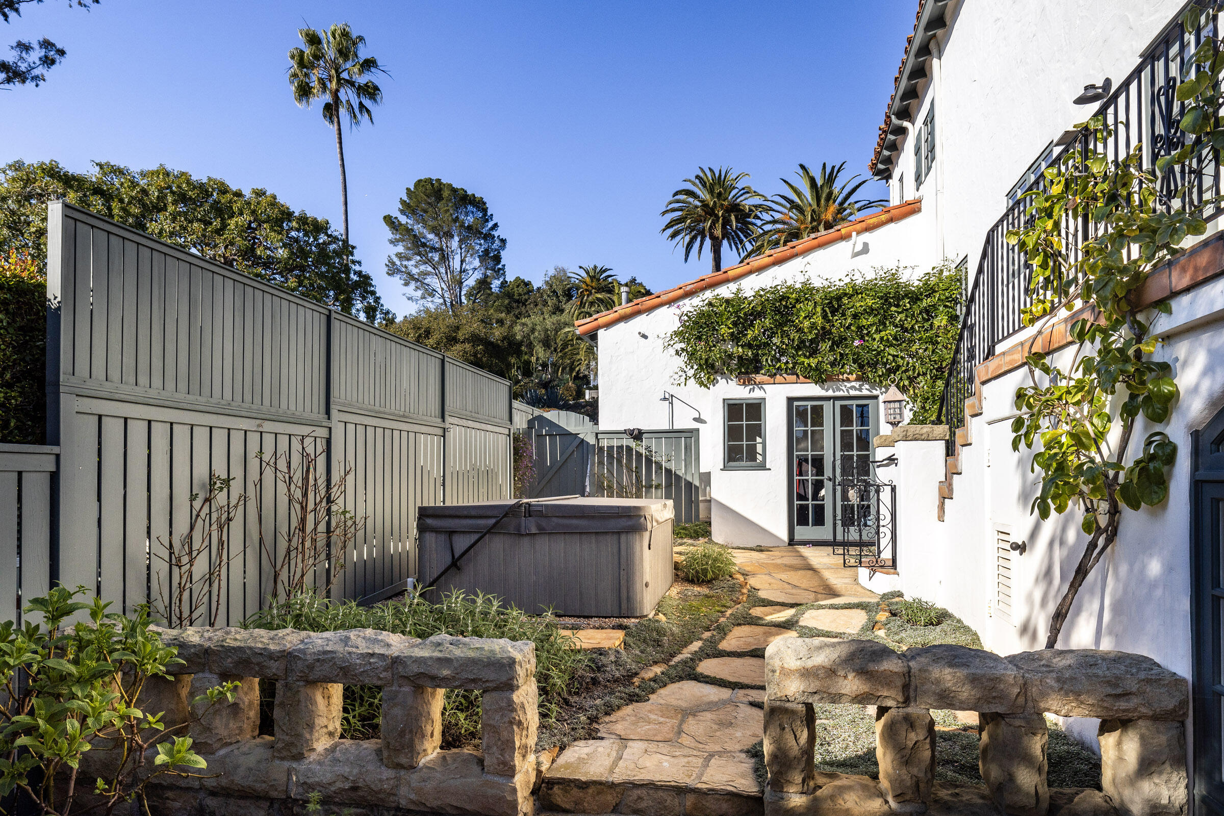 1933 Mission Ridge Road Santa Barbara, CA 93103 - Photo 23 of 30 a backyard of a house with table and chairs potted plants