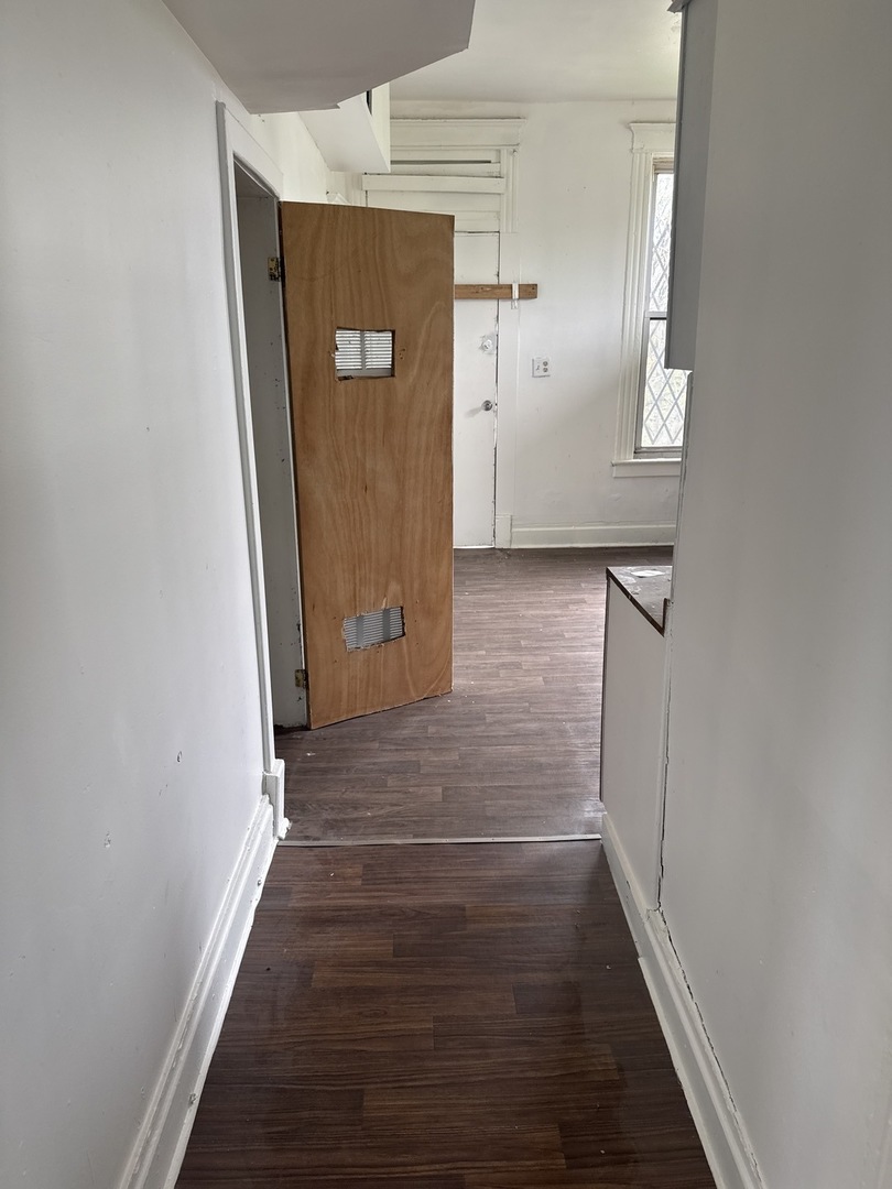 1655 South Ridgeway Avenue Chicago, IL 60623 - Photo 13 of 19 a view of a hallway with wooden floor