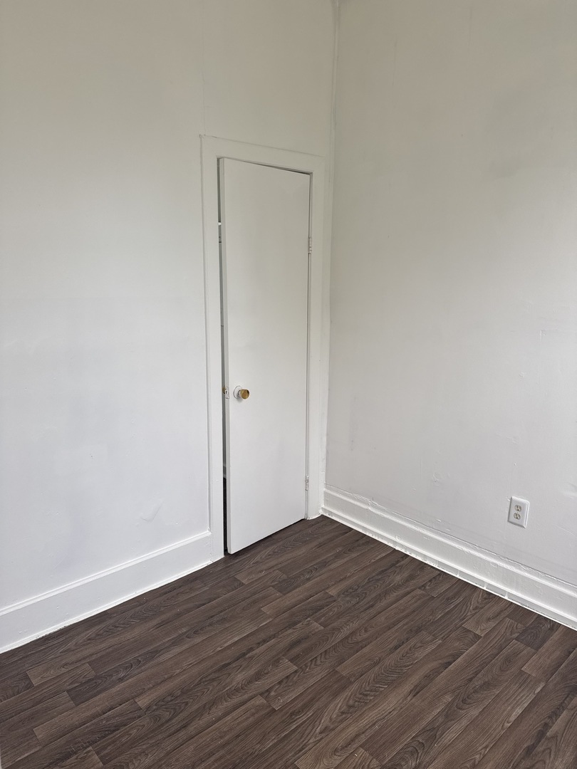 1655 South Ridgeway Avenue Chicago, IL 60623 - Photo 14 of 19 a view of an empty room with wooden floor