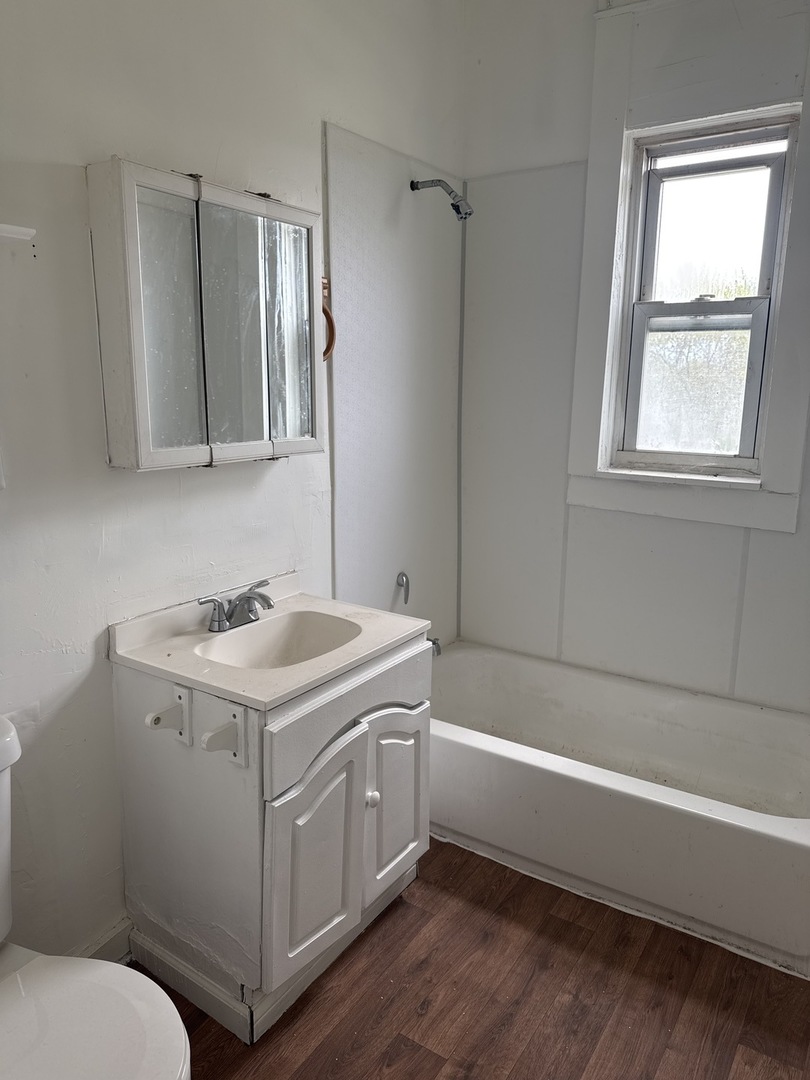 1655 South Ridgeway Avenue Chicago, IL 60623 - Photo 15 of 19 a bathroom with a sink toilet vanity and tub