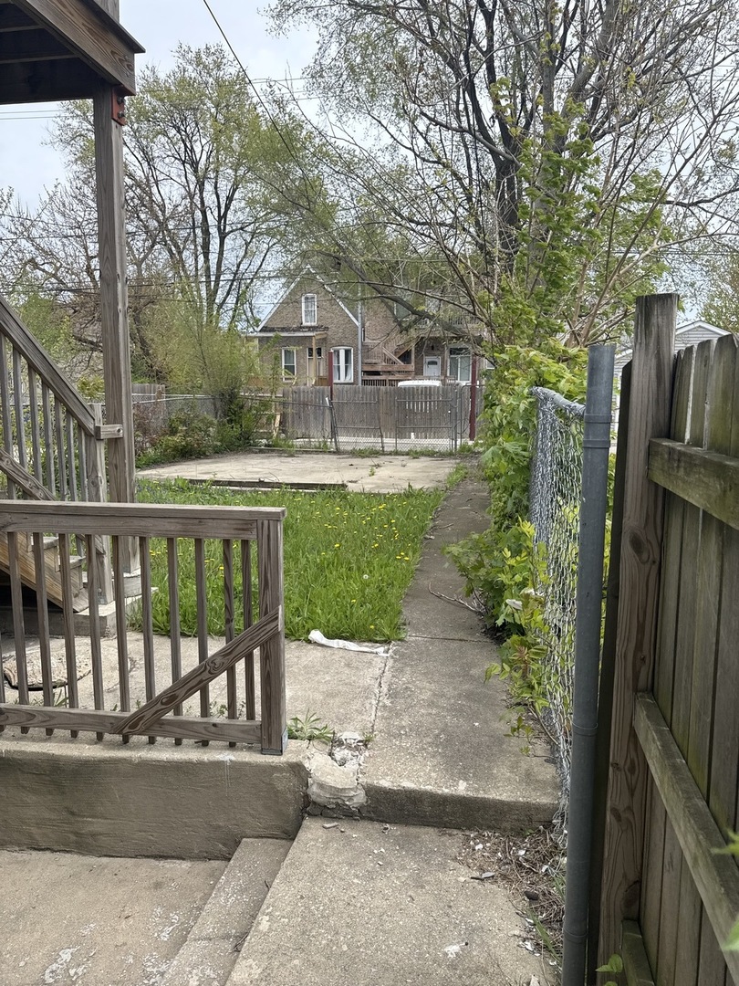 1655 South Ridgeway Avenue Chicago, IL 60623 - Photo 19 of 19 a front view of a house with a yard