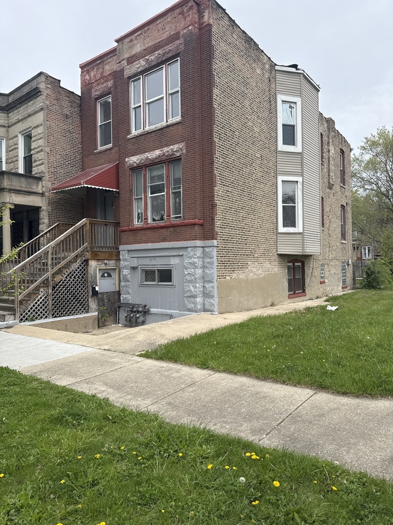 1655 South Ridgeway Avenue Chicago, IL 60623 - Photo 2 of 19 a front view of a house with a yard and garage