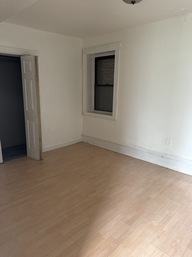 1655 South Ridgeway Avenue Chicago, IL 60623 - Photo 3 of 19 an empty room with a window