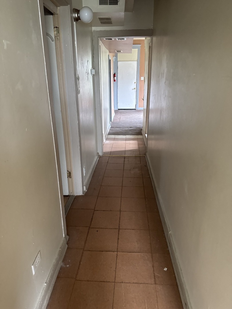 1655 South Ridgeway Avenue Chicago, IL 60623 - Photo 8 of 19 a hallway with sliding door and yard in back