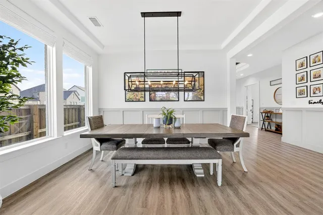 a living room with a table chairs and a table