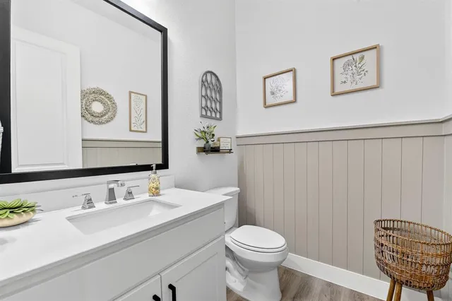 a bathroom with a toilet a sink and mirror