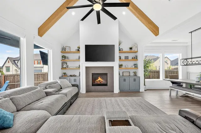 a living room with furniture a fireplace and a flat screen tv