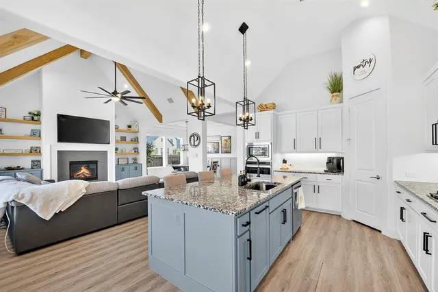 a kitchen with stainless steel appliances granite countertop a stove and kitchen view