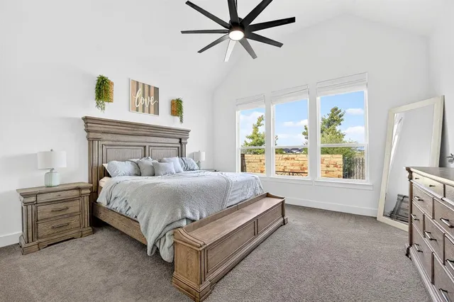 a bedroom with a bed a dresser next to a window