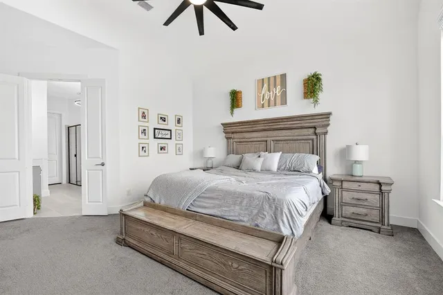 a bedroom with a bed and a chandelier