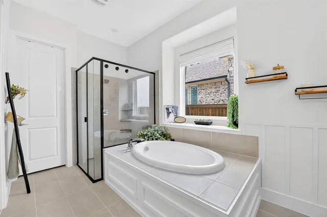 a bathroom with a granite countertop sink a toilet a mirror and shower