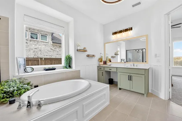 a bathroom with a granite countertop sink mirror bathtub and toilet