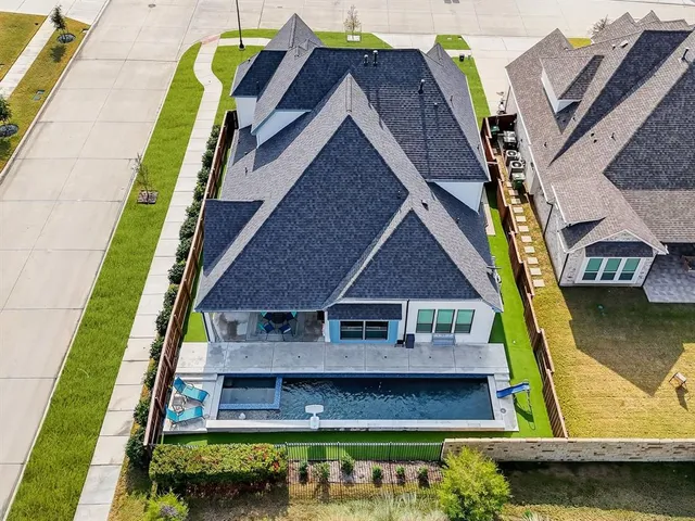 a view of a swimming pool with outdoor seating and plants