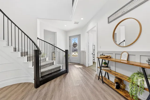 a view of a livingroom with furniture a dinning room and wooden floor