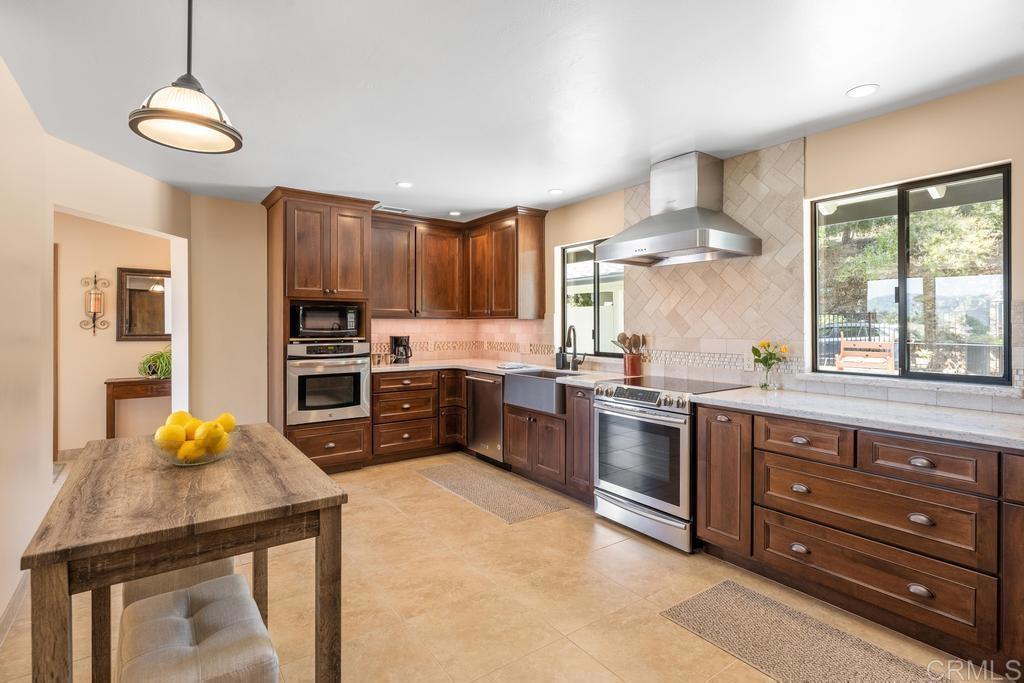 1057 Riverview Drive Fallbrook, CA 92028 - Photo 2 of 69 a kitchen with granite countertop a stove a sink and a refrigerator