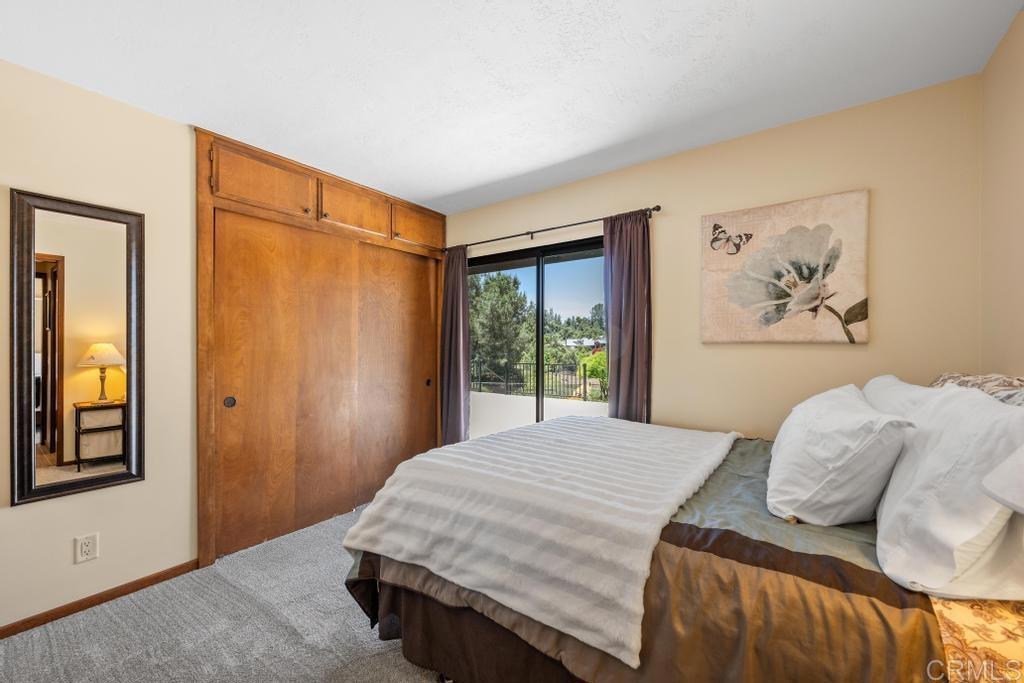 1057 Riverview Drive Fallbrook, CA 92028 - Photo 21 of 69 a bedroom with a bed and a painting on the wall