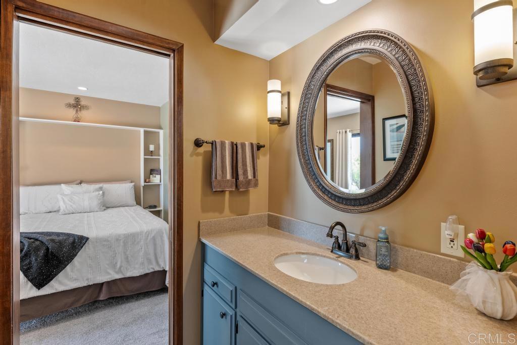 1057 Riverview Drive Fallbrook, CA 92028 - Photo 23 of 69 a bathroom with a granite countertop double vanity sink and a mirror