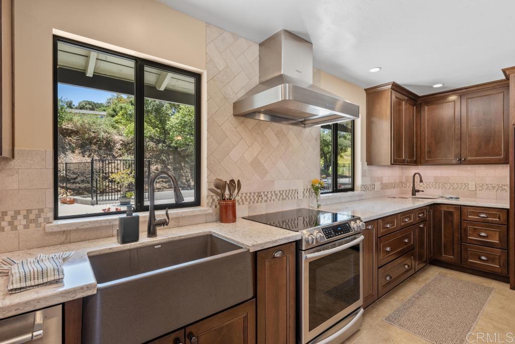 1057 Riverview Drive Fallbrook, CA 92028 - Photo 3 of 69 a kitchen with stainless steel appliances a sink stove and cabinets