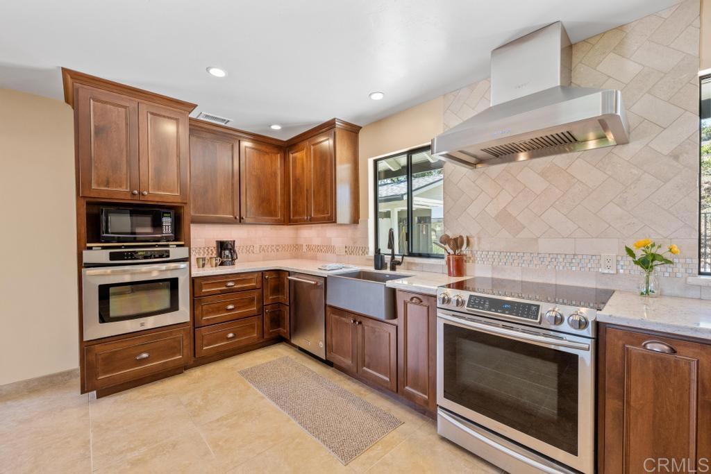 1057 Riverview Drive Fallbrook, CA 92028 - Photo 5 of 69 a kitchen with granite countertop a stove and cabinets