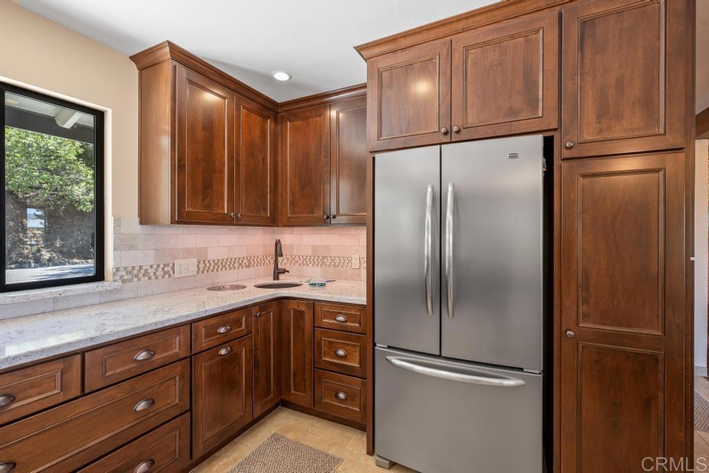 1057 Riverview Drive Fallbrook, CA 92028 - Photo 6 of 69 a kitchen with stainless steel appliances granite countertop a refrigerator and a sink