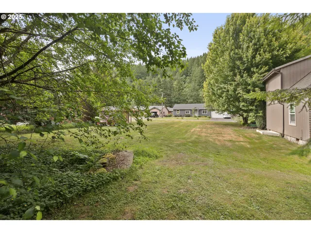 a backyard of a house with a yard and outdoor seating
