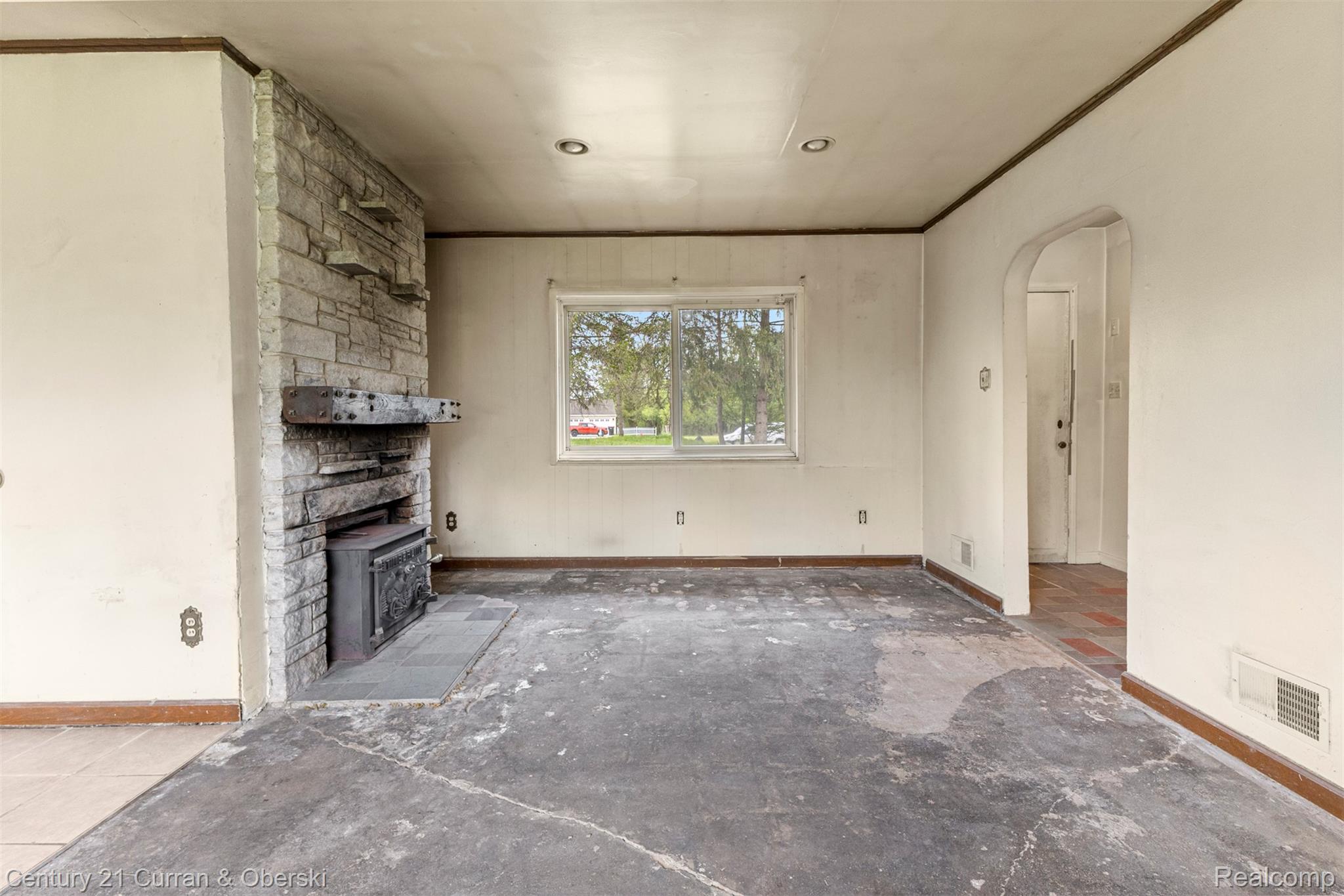 25205 Inkster Road Farmington, MI 48336 - Photo 10 of 46 Unfurnished living room with arched walkways and crown molding