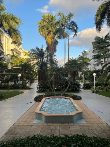 a view of a yard with palm trees