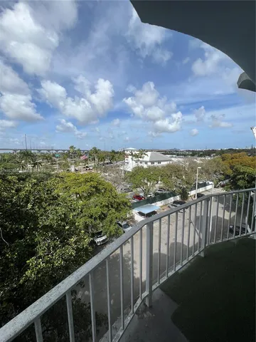 a view of a house with a backyard porch and sitting area