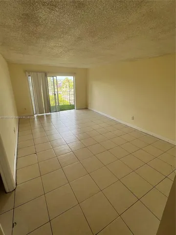 a view of an empty room and a window