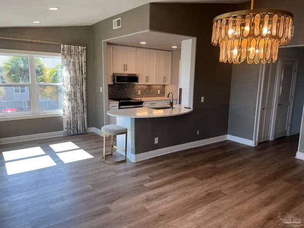 a view of kitchen with cabinets and wooden floor
