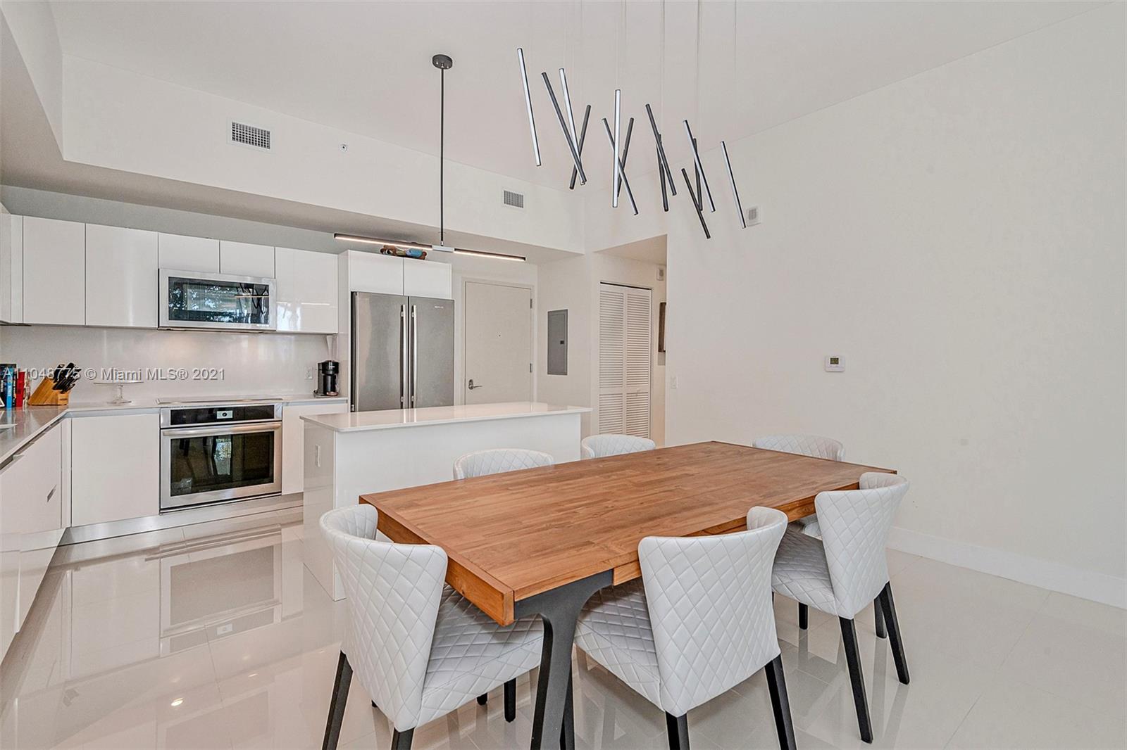a open kitchen with a table and chairs in it