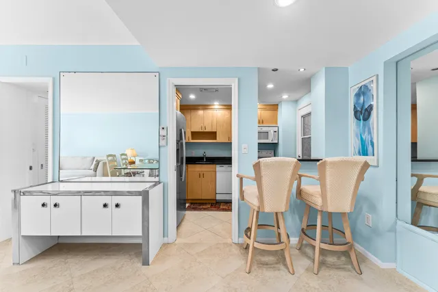 a living room with furniture and large windows