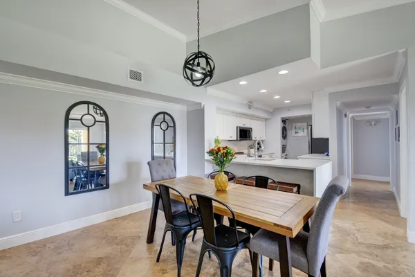 a kitchen with stainless steel appliances white cabinets and a refrigerator