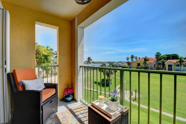 a kitchen with a sink white cabinets and white appliances