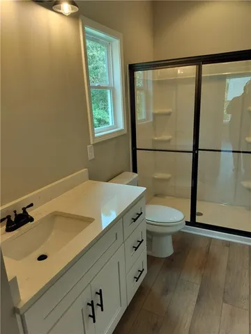 a bathroom with a sink toilet and shower