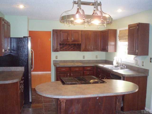 5600 Blacket Court Raleigh, NC 27604 - Photo 4 of 11 a kitchen with cabinets a sink and a stove