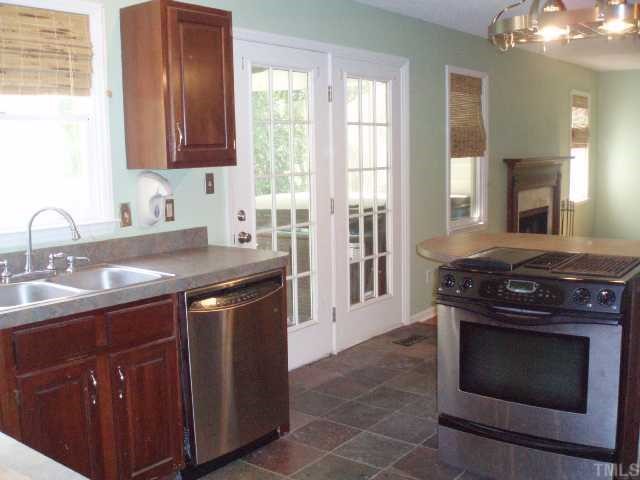 5600 Blacket Court Raleigh, NC 27604 - Photo 5 of 11 a kitchen with a stove top oven sink and cabinets