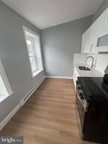 a kitchen with granite countertop a stove and a sink