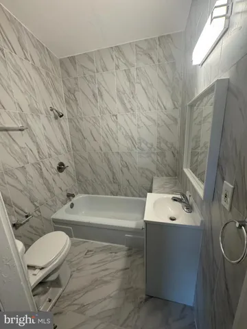 a bathroom with a sink a toilet and bathtub