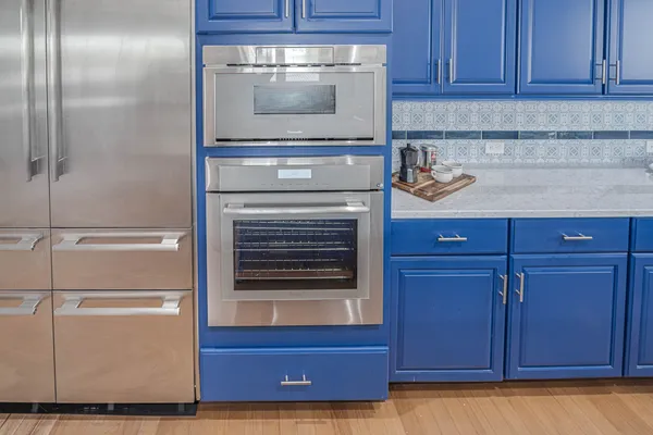 a kitchen with granite countertop wood cabinets and stainless steel appliances
