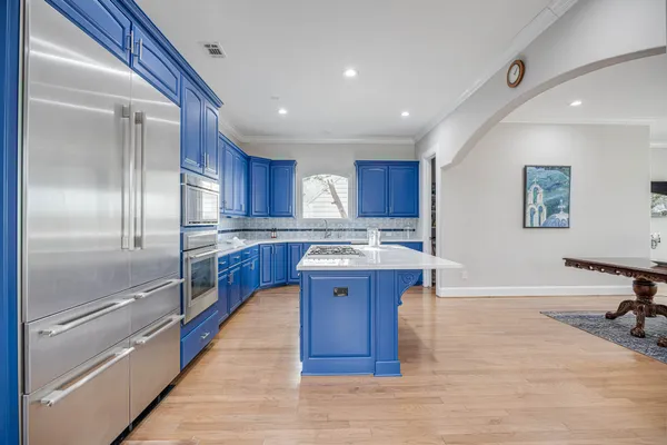 a kitchen with cabinets and stainless steel appliances
