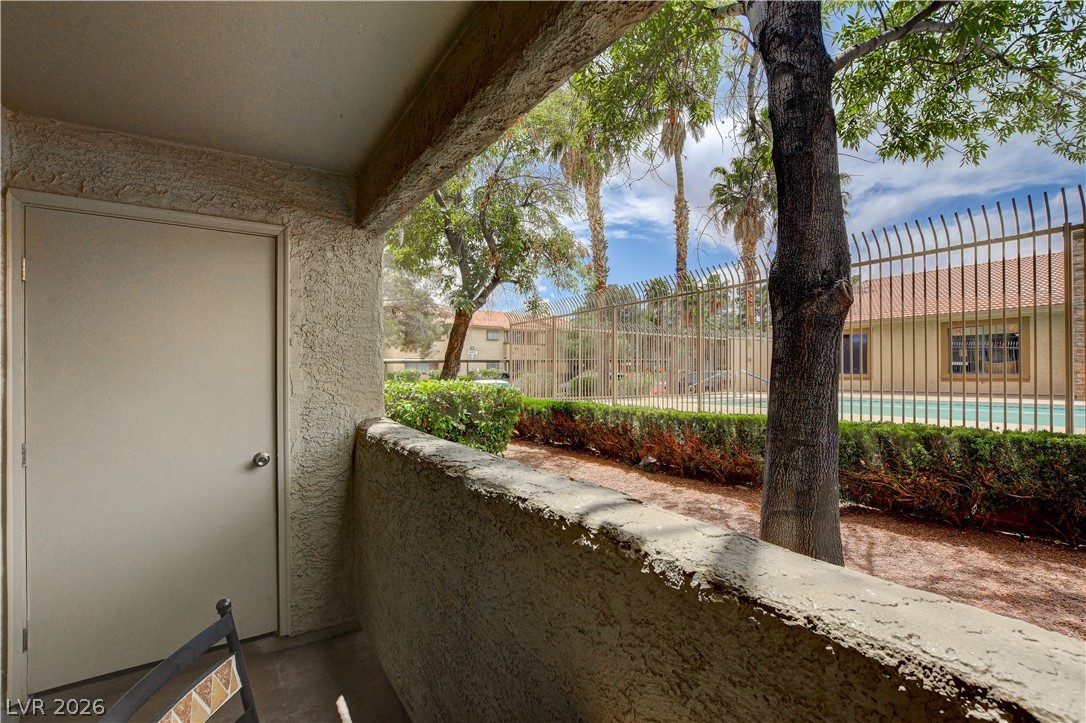 7200 West Pirates Cove Road, Unit 1026 Las Vegas, NV 89145 - Photo 28 of 35 Enjoy tranquil views of the community pool and lush landscaping from this charming patio.