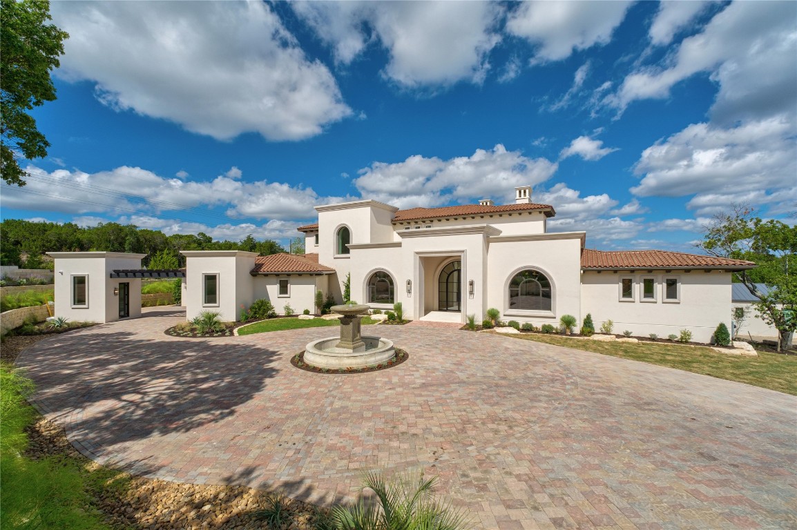 a view of a white house with a patio