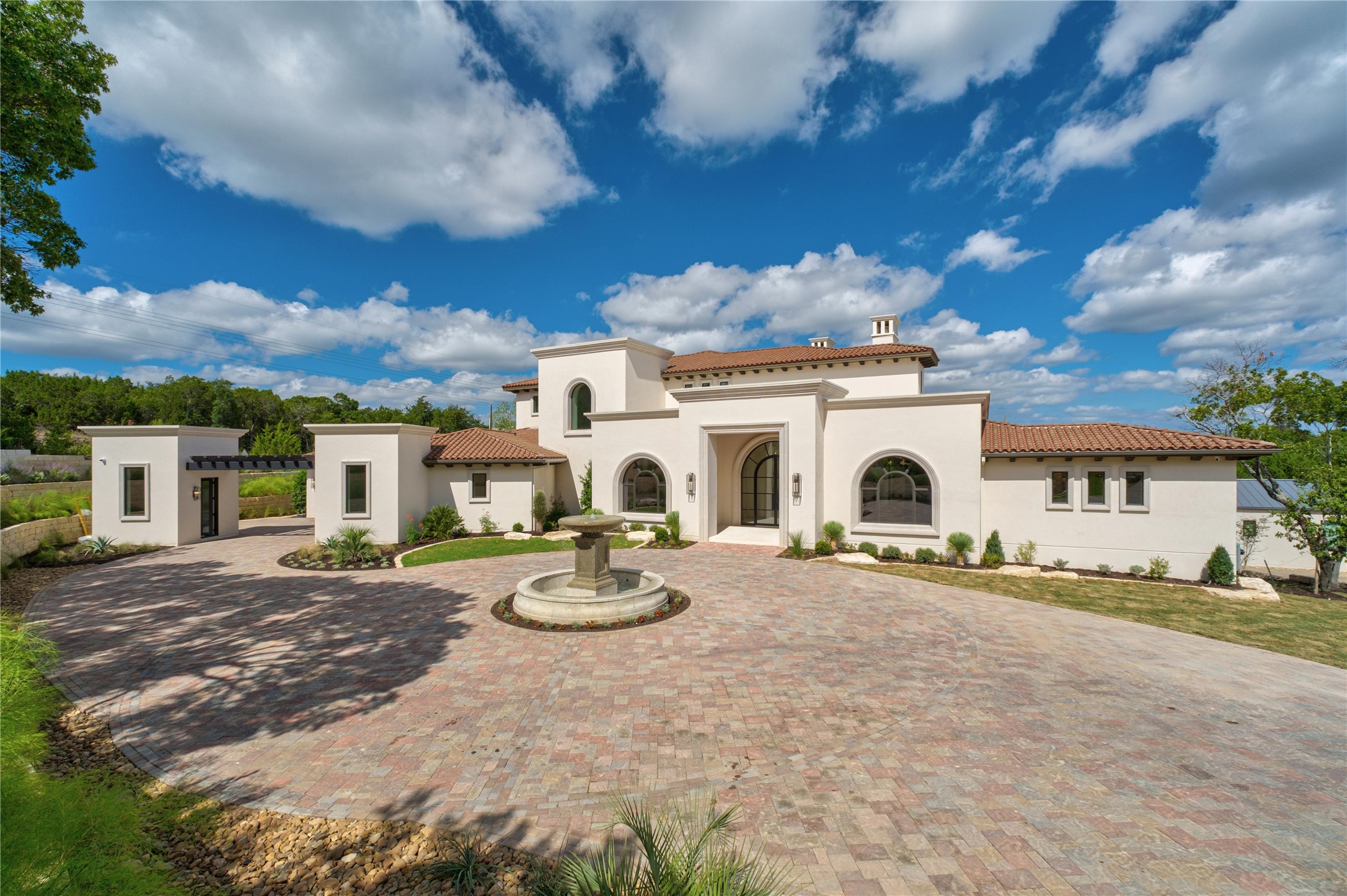 a view of a white house with a patio