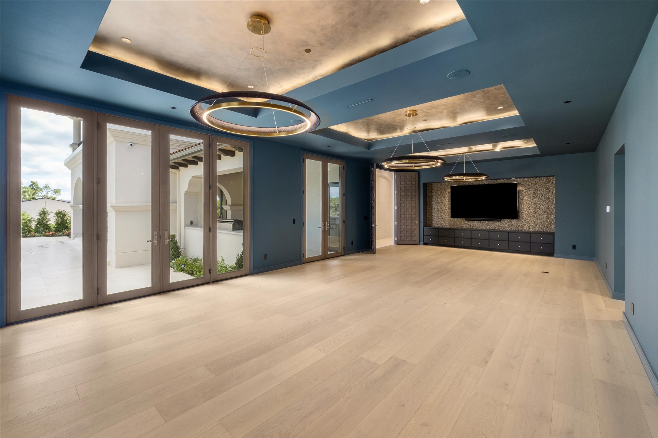 1104 Marly Way Austin, TX 78733 - Photo 6 of 13 a view of an empty room with a fireplace and a large window