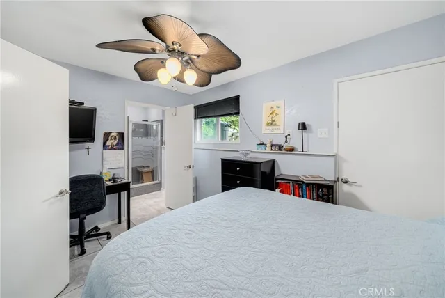 a bed room with a bed and a chandelier