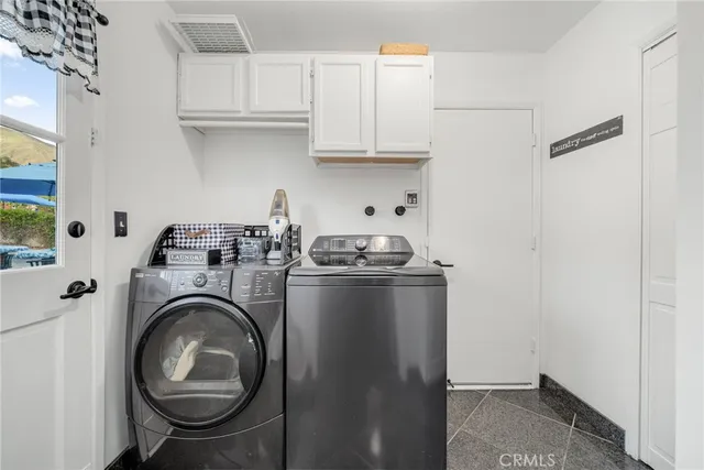 a utility room with sink dryer and washer